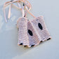 Sleeveless pink Freckles Top with black polka dots on a light background.