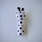 Pon Pon Rattler toy with black polka dots and antennae.