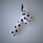 Pon Pon Rattler toy with black polka dots on a white background.