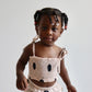 Toddler wearing Freckles Top with polka dot pattern.
